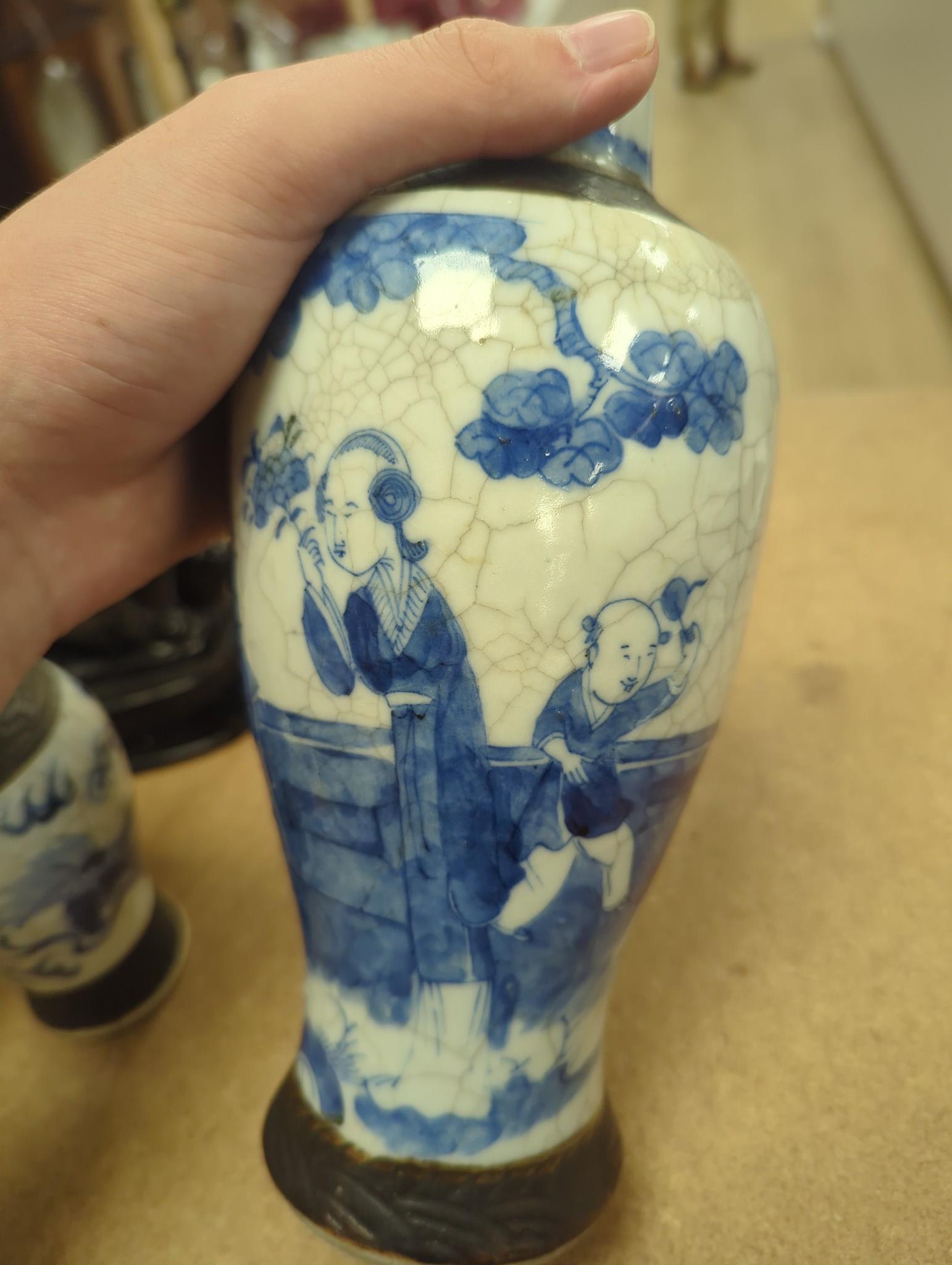 Three Chinese blue and white crackle glaze vases, a famille rose brush pot, late 19th/early 20th century, a crackle glaze ginger jar and a carved soapstone lion-dog (6)